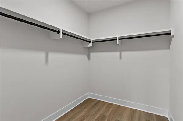 an empty room with wooden floor and a window