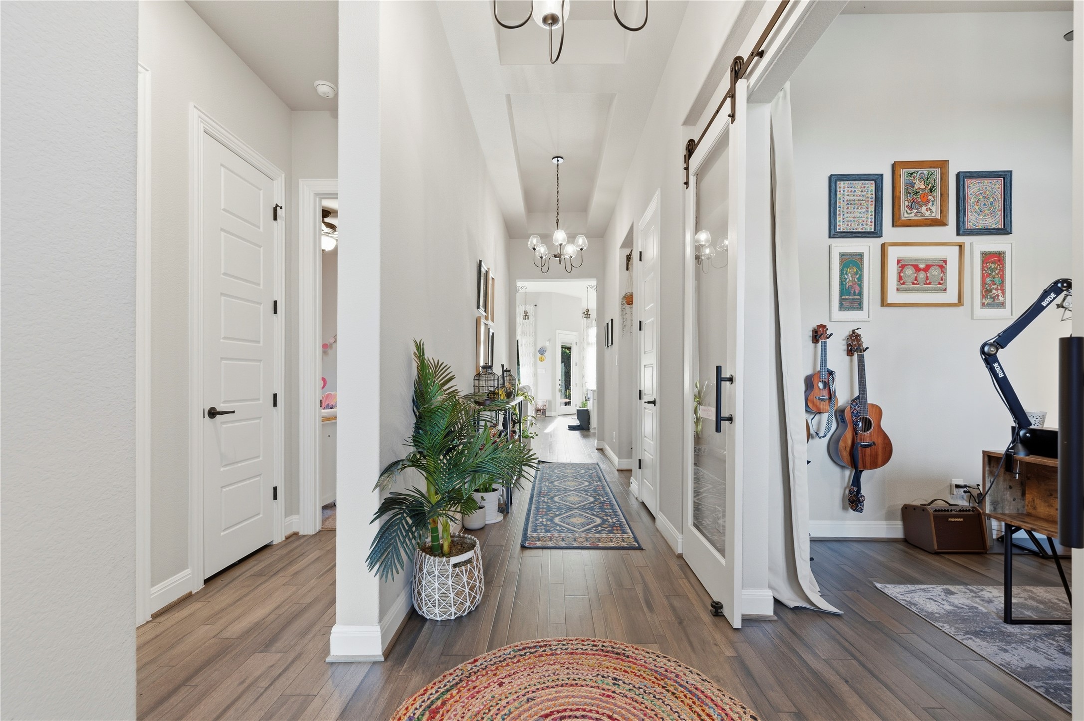138 Rpd Spgs Cove Georgetown, TX 78628 - Photo 4 of 37 a view of a hallway with wooden floor and a potted plant