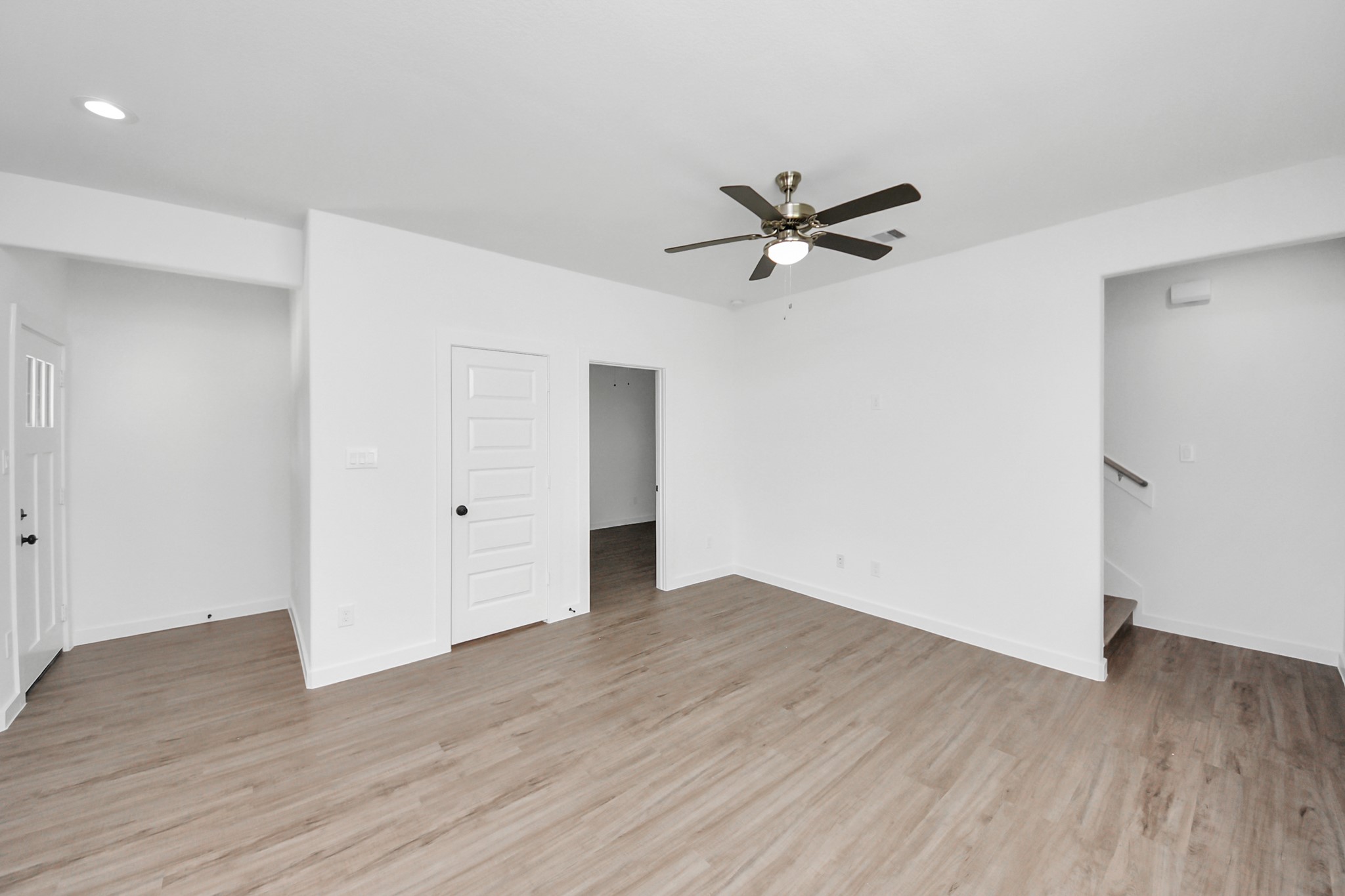 7312 Wileyvale Road, Unit C Houston, TX 77016 - Photo 19 of 39 an empty room with wooden floor fan and windows