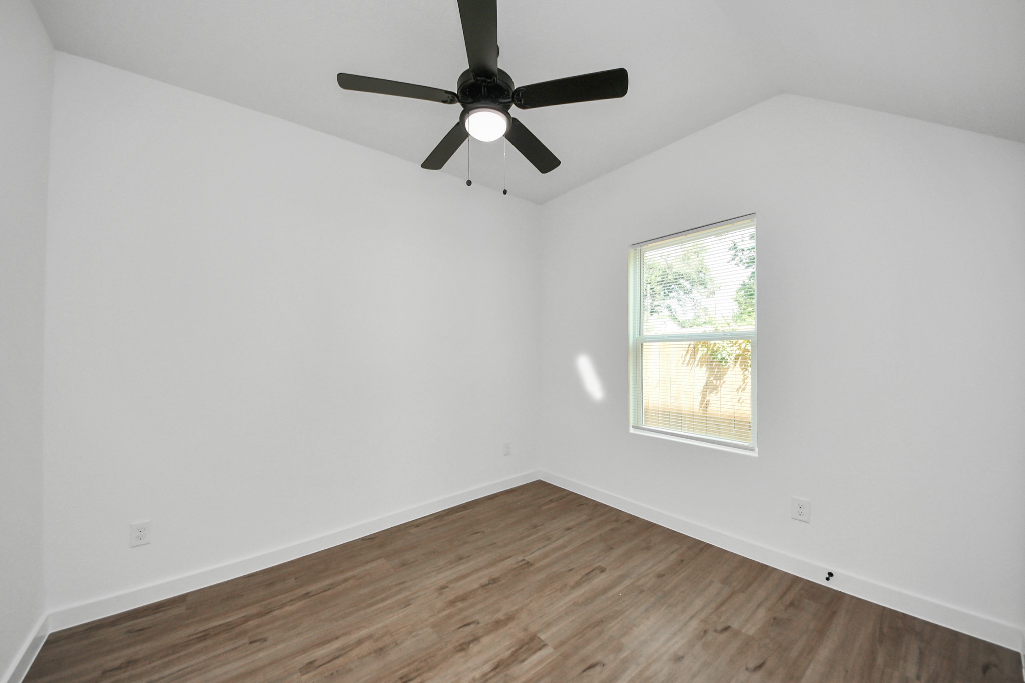 7312 Wileyvale Road, Unit C Houston, TX 77016 - Photo 22 of 39 an empty room with a window and a ceiling fan