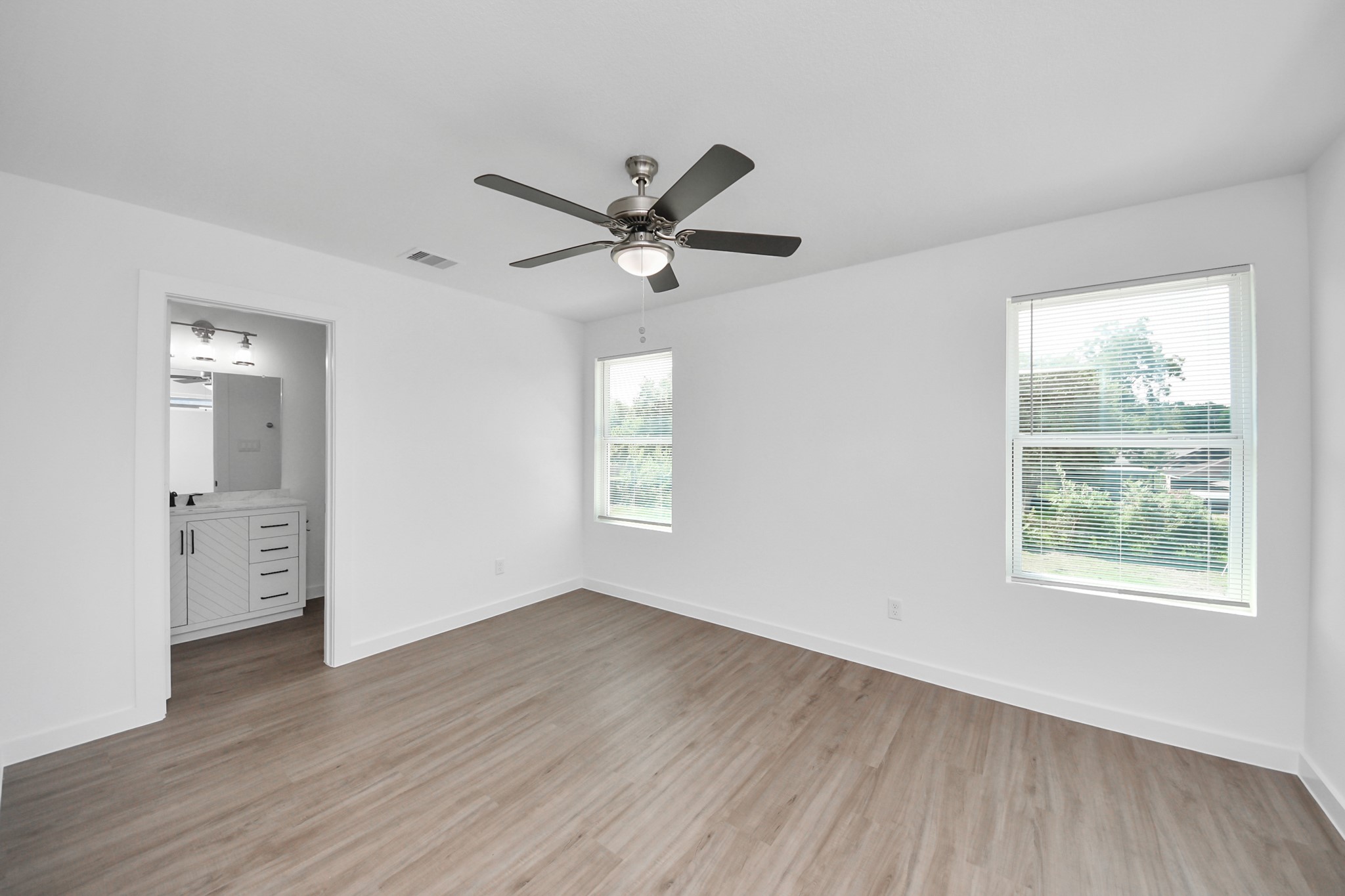 7312 Wileyvale Road, Unit C Houston, TX 77016 - Photo 27 of 39 an empty room with wooden floor and windows