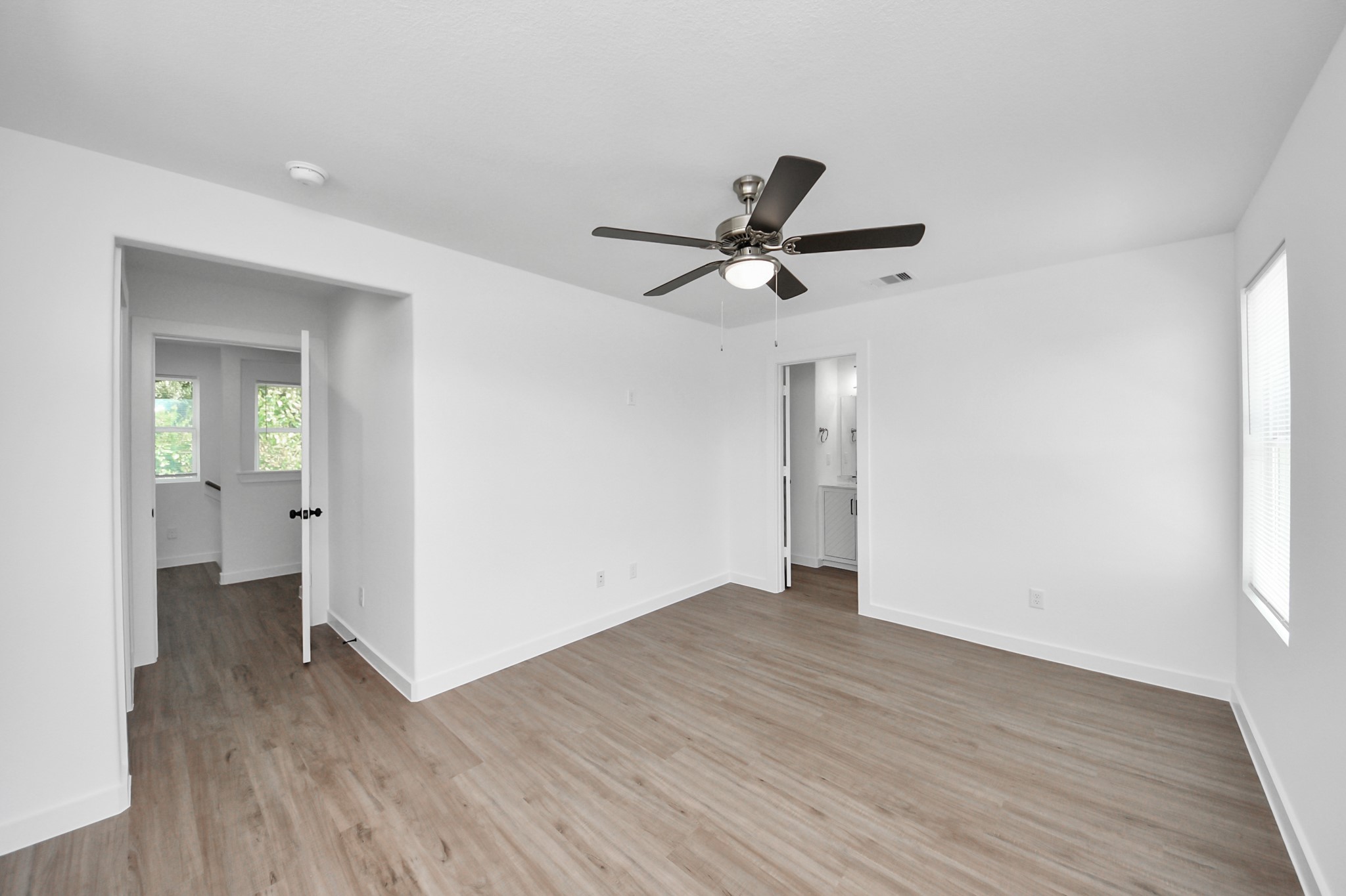7312 Wileyvale Road, Unit C Houston, TX 77016 - Photo 28 of 39 an empty room with wooden floor and a ceiling fan