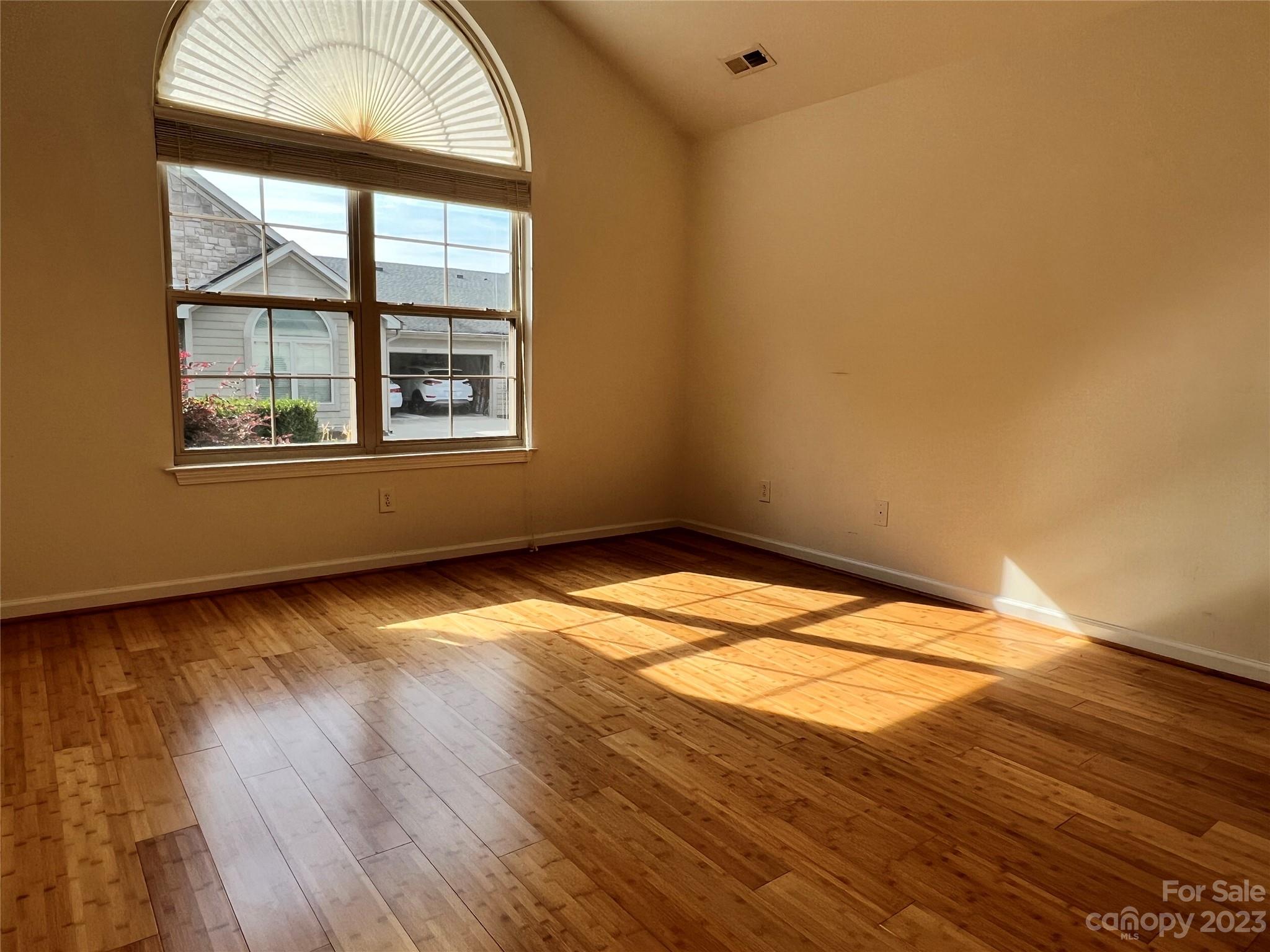 721 Ledgestone Court Tega Cay, SC 29708 - Photo 11 of 35 an empty room with wooden floor and windows