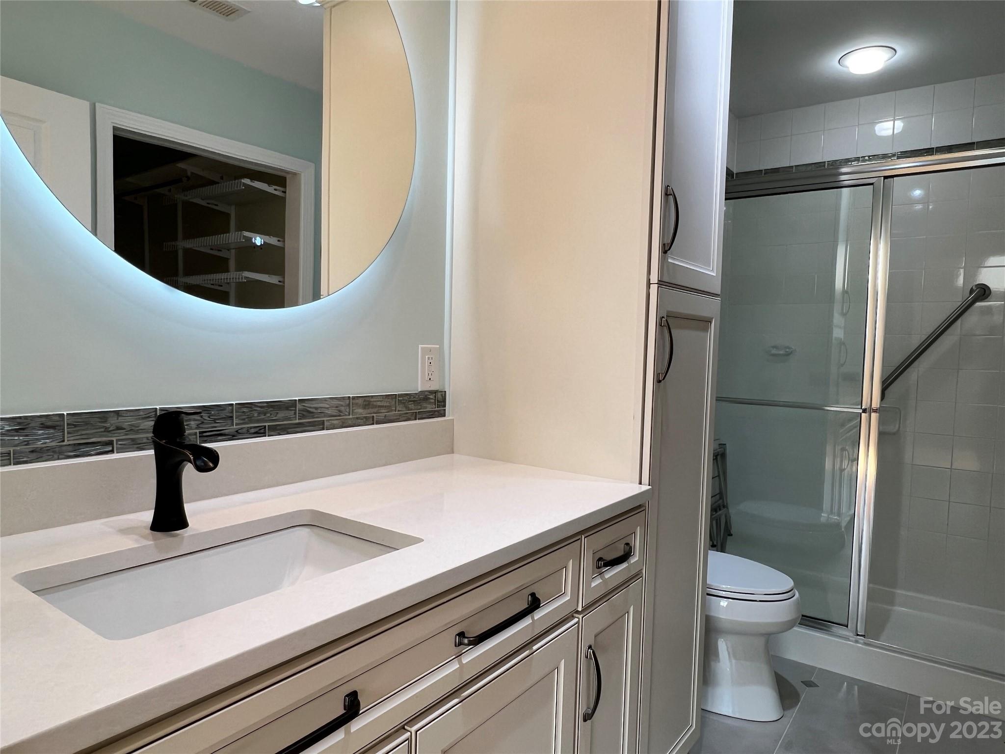 721 Ledgestone Court Tega Cay, SC 29708 - Photo 13 of 35 a bathroom with a toilet a sink and mirror
