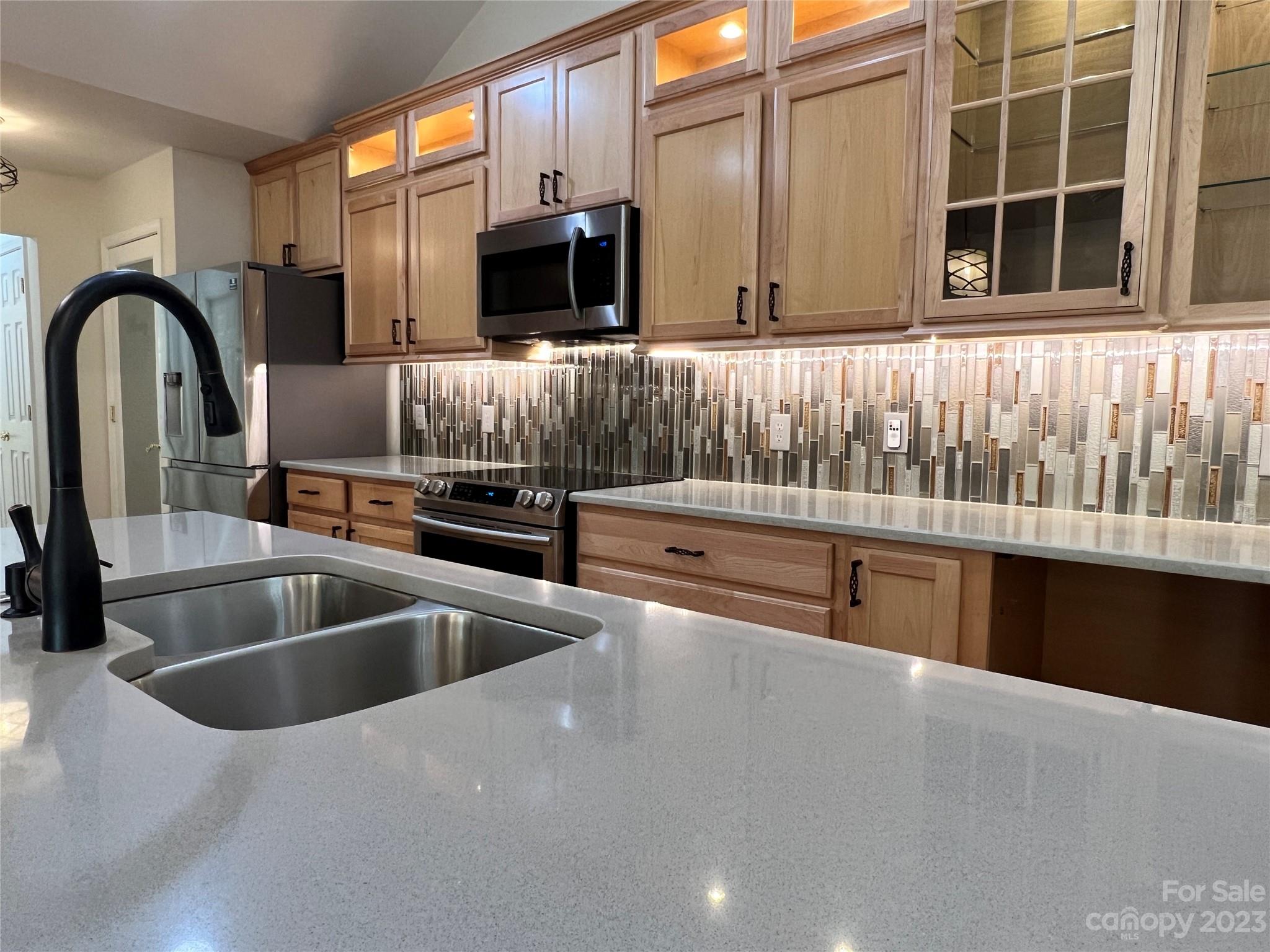 721 Ledgestone Court Tega Cay, SC 29708 - Photo 17 of 35 a kitchen with stainless steel appliances a sink and a microwave