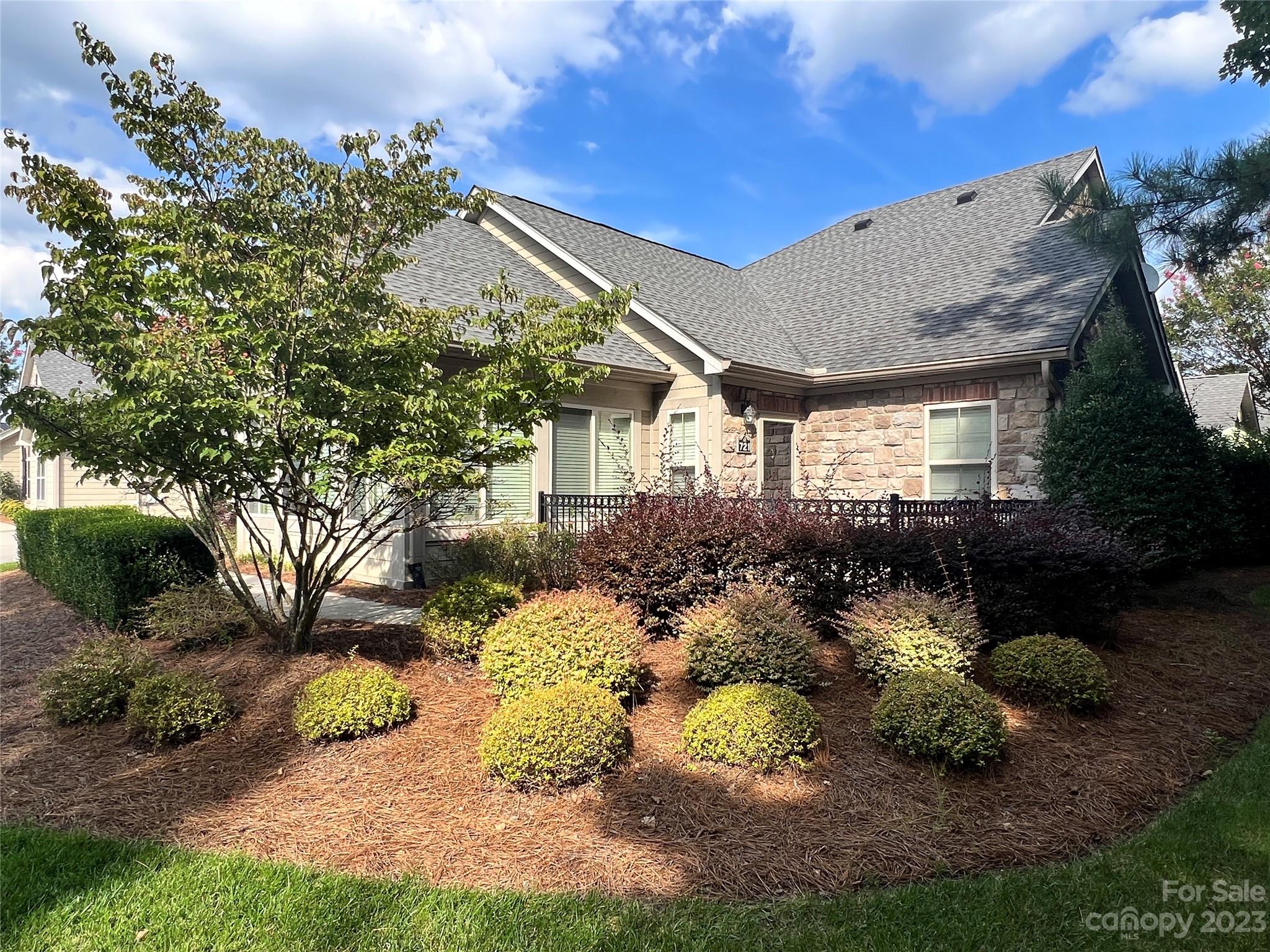 721 Ledgestone Court Tega Cay, SC 29708 - Photo 2 of 35 a view of backyard with plants and outdoor seating