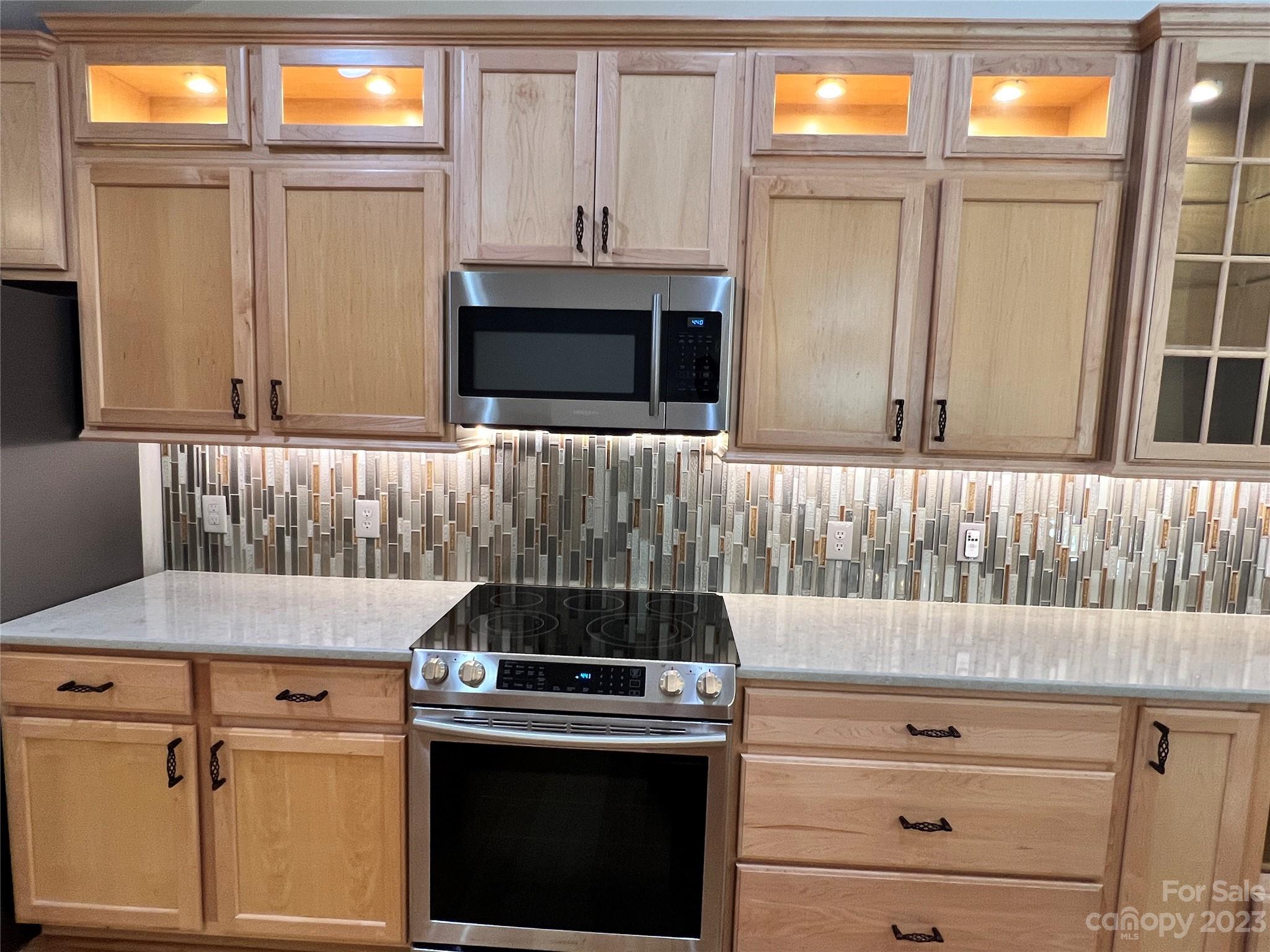 721 Ledgestone Court Tega Cay, SC 29708 - Photo 21 of 35 a kitchen with granite countertop a stove and a microwave