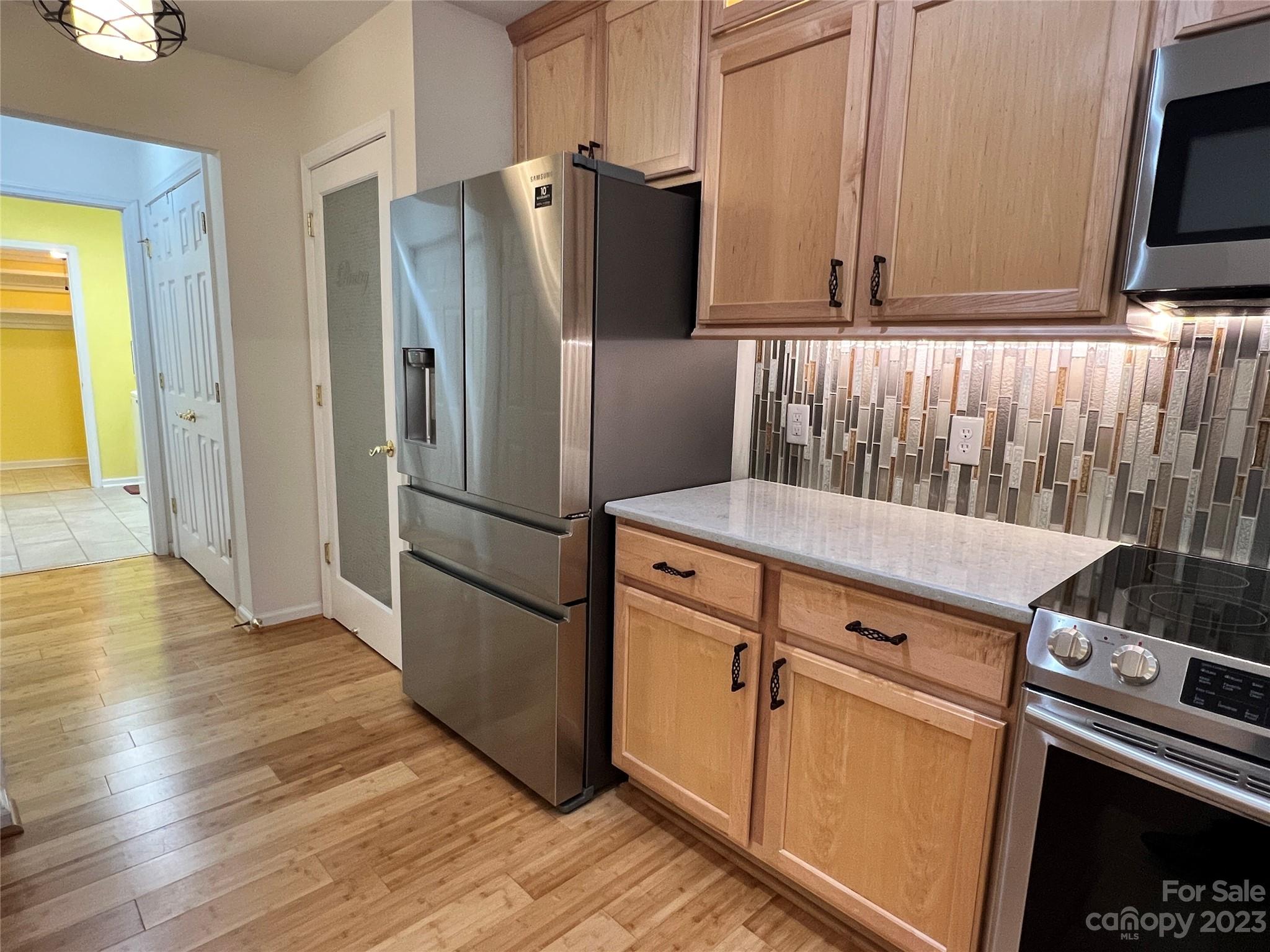 721 Ledgestone Court Tega Cay, SC 29708 - Photo 22 of 35 a kitchen with appliances and a refrigerator