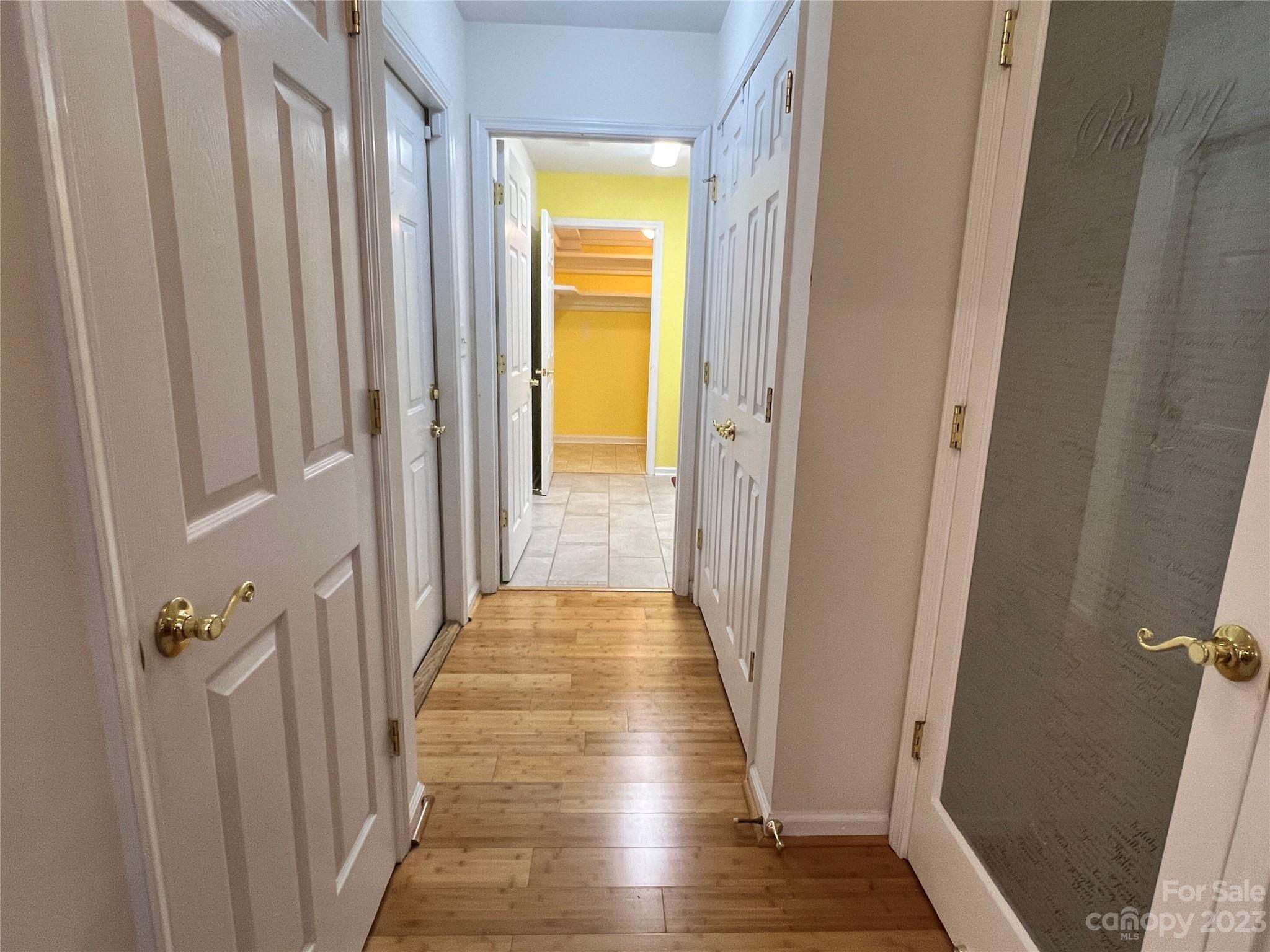 721 Ledgestone Court Tega Cay, SC 29708 - Photo 25 of 35 a view of a hallway with wooden floor and staircase