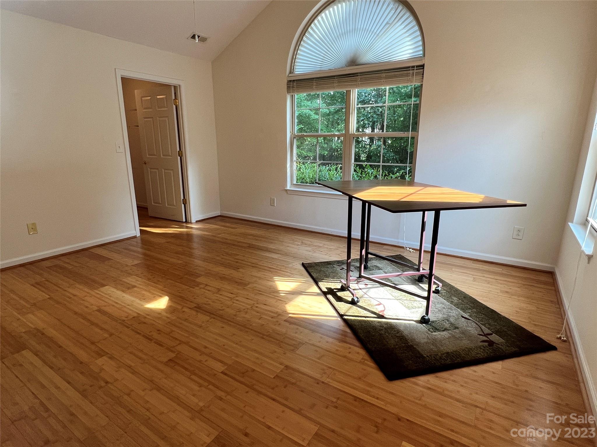 721 Ledgestone Court Tega Cay, SC 29708 - Photo 30 of 35 a view of a room with wooden floor a glass table and windows