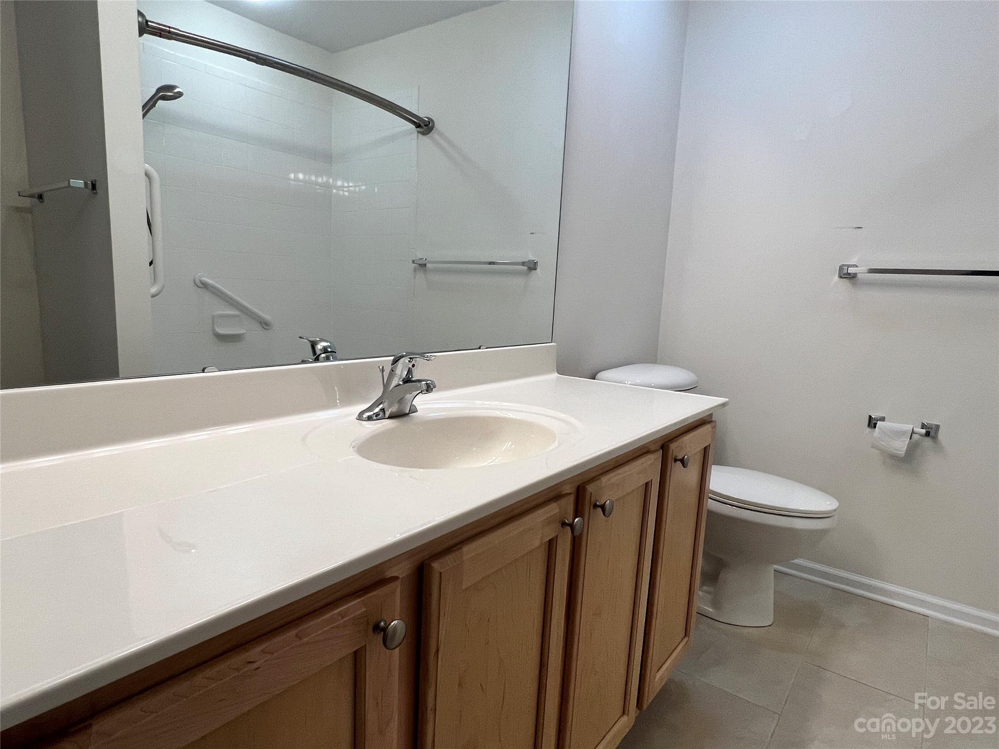 721 Ledgestone Court Tega Cay, SC 29708 - Photo 33 of 35 a bathroom with a sink a toilet and a mirror