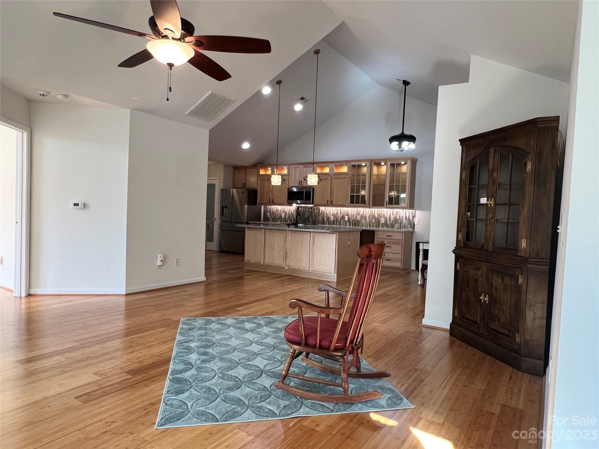 721 Ledgestone Court Tega Cay, SC 29708 - Photo 7 of 35 a room with lots of wooden furniture and a chandelier