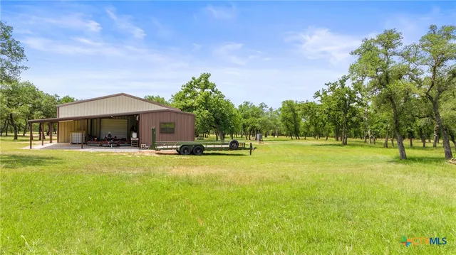 a front view of house with yard and trees