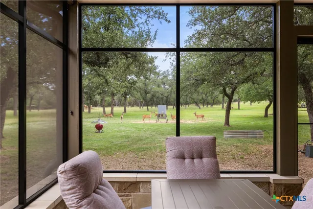 a view of a large room with large windows and a table