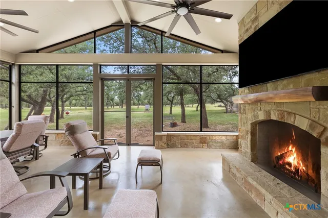 a living room with furniture a fireplace and a flat screen tv