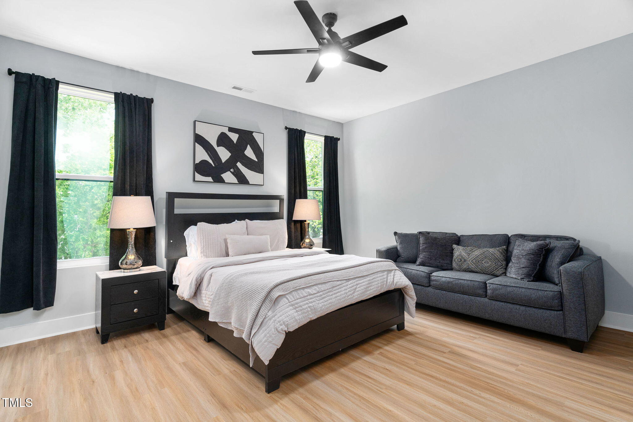 2325 Sheffield Road, Unit 102 Raleigh, NC 27610 - Photo 15 of 38 a spacious bedroom with a bed couch and a window