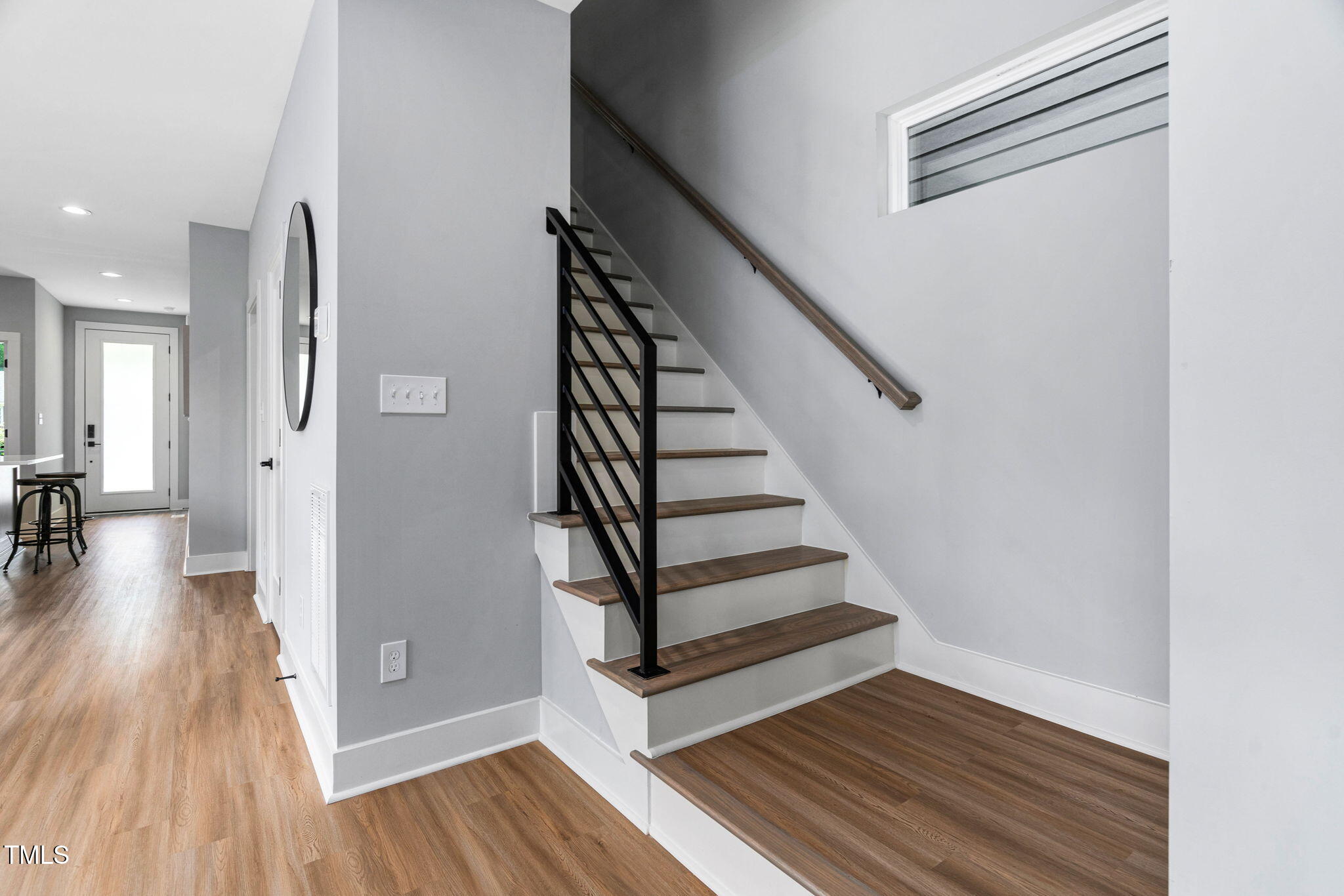 2325 Sheffield Road, Unit 102 Raleigh, NC 27610 - Photo 16 of 38 a view of a hallway with wooden floor and staircase