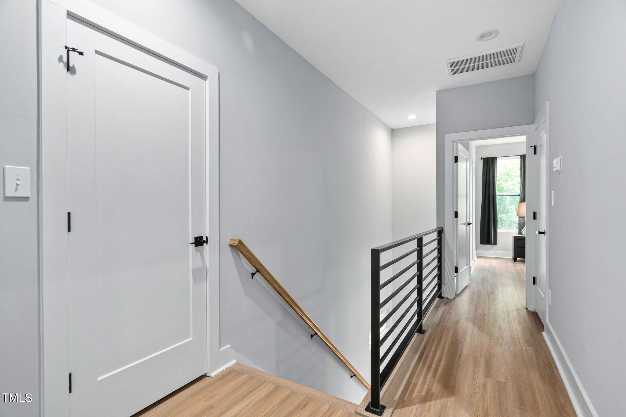 2325 Sheffield Road, Unit 102 Raleigh, NC 27610 - Photo 17 of 38 a view of a hallway with wooden floor and staircase