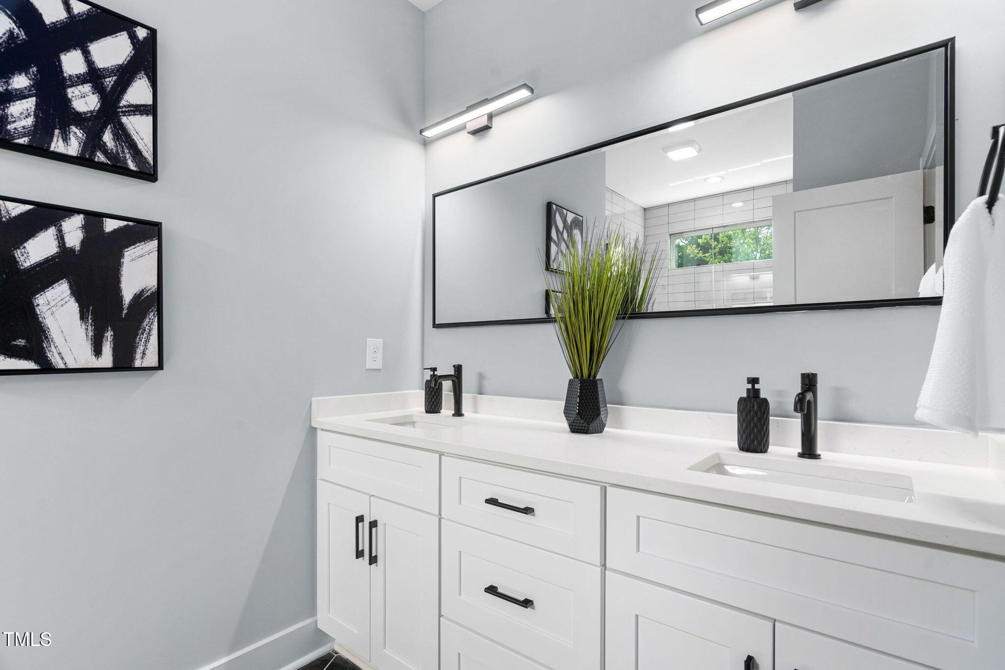 2325 Sheffield Road, Unit 102 Raleigh, NC 27610 - Photo 22 of 38 a bathroom with a sink and a mirror