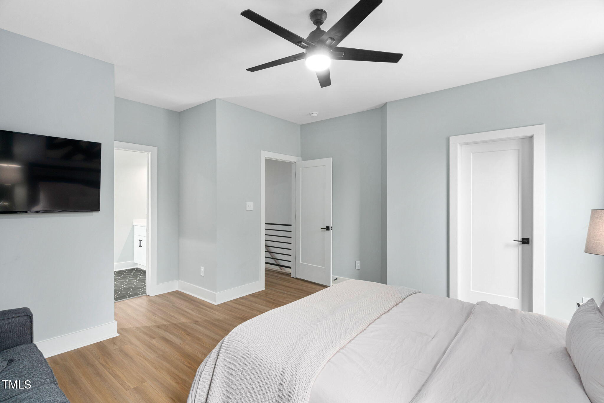 2325 Sheffield Road, Unit 102 Raleigh, NC 27610 - Photo 25 of 38 a bedroom with a bed and a flat screen tv