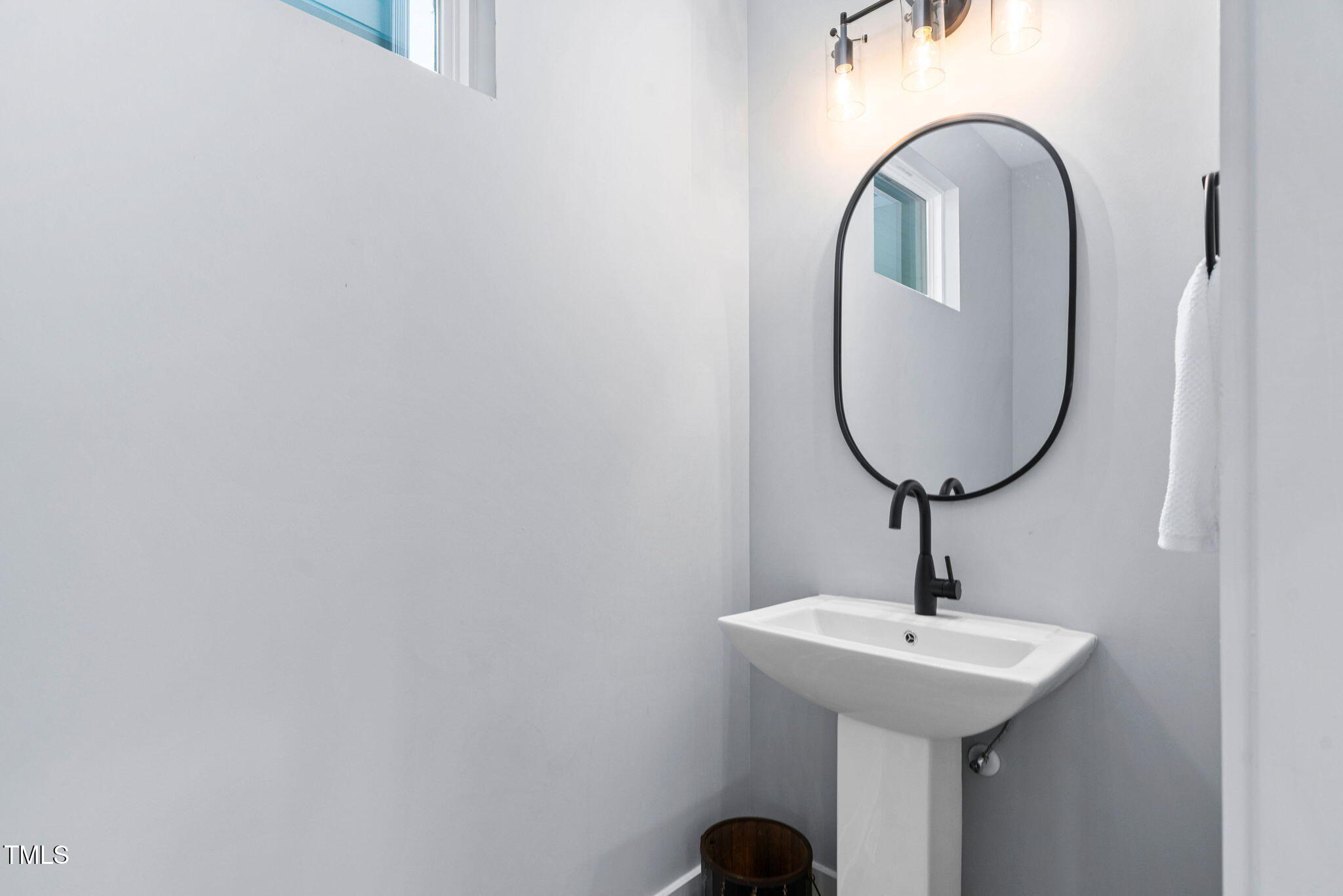 2325 Sheffield Road, Unit 102 Raleigh, NC 27610 - Photo 26 of 38 a bathroom with a sink and mirror