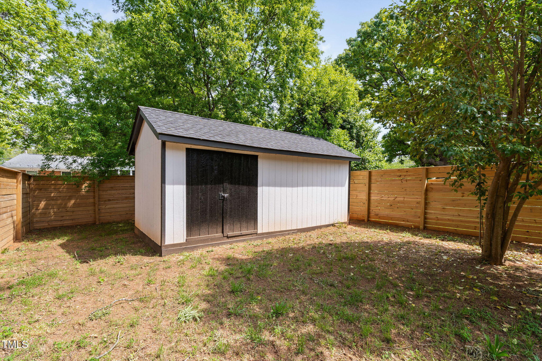 2325 Sheffield Road, Unit 102 Raleigh, NC 27610 - Photo 31 of 38 a view of backyard with large tree and wooden fence
