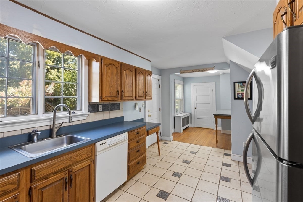 14 Cottage Street Sharon, MA 02067 - Photo 13 of 27 a large kitchen with a large window and stainless steel appliances