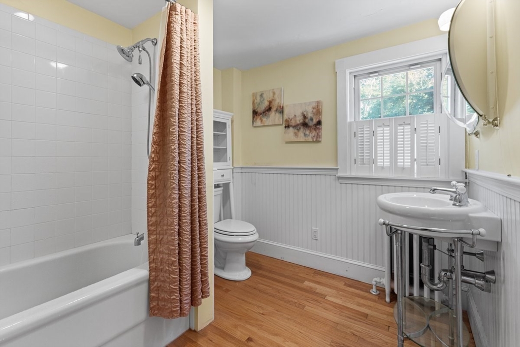 14 Cottage Street Sharon, MA 02067 - Photo 20 of 27 a bathroom with a sink a toilet and a mirror