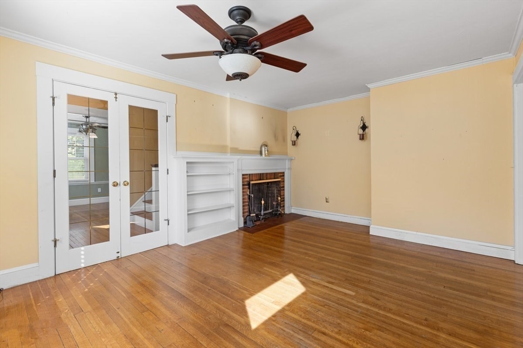 14 Cottage Street Sharon, MA 02067 - Photo 8 of 27 a view of a livingroom with wooden floor and a ceiling fan