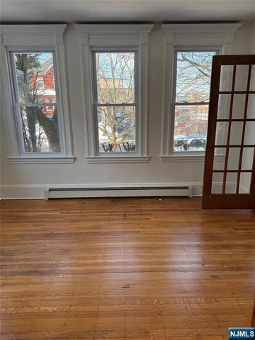 a view of a yard with wooden fence