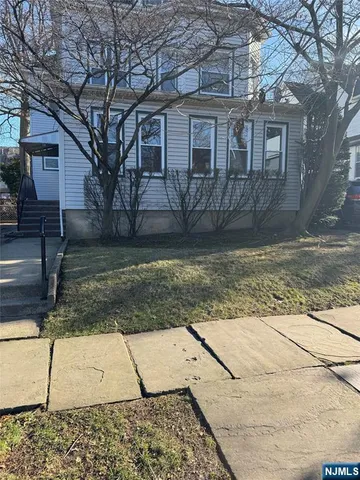 a view of a house with a backyard