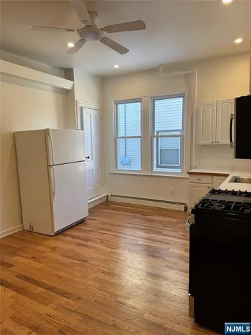 a kitchen with a refrigerator and a stove top oven
