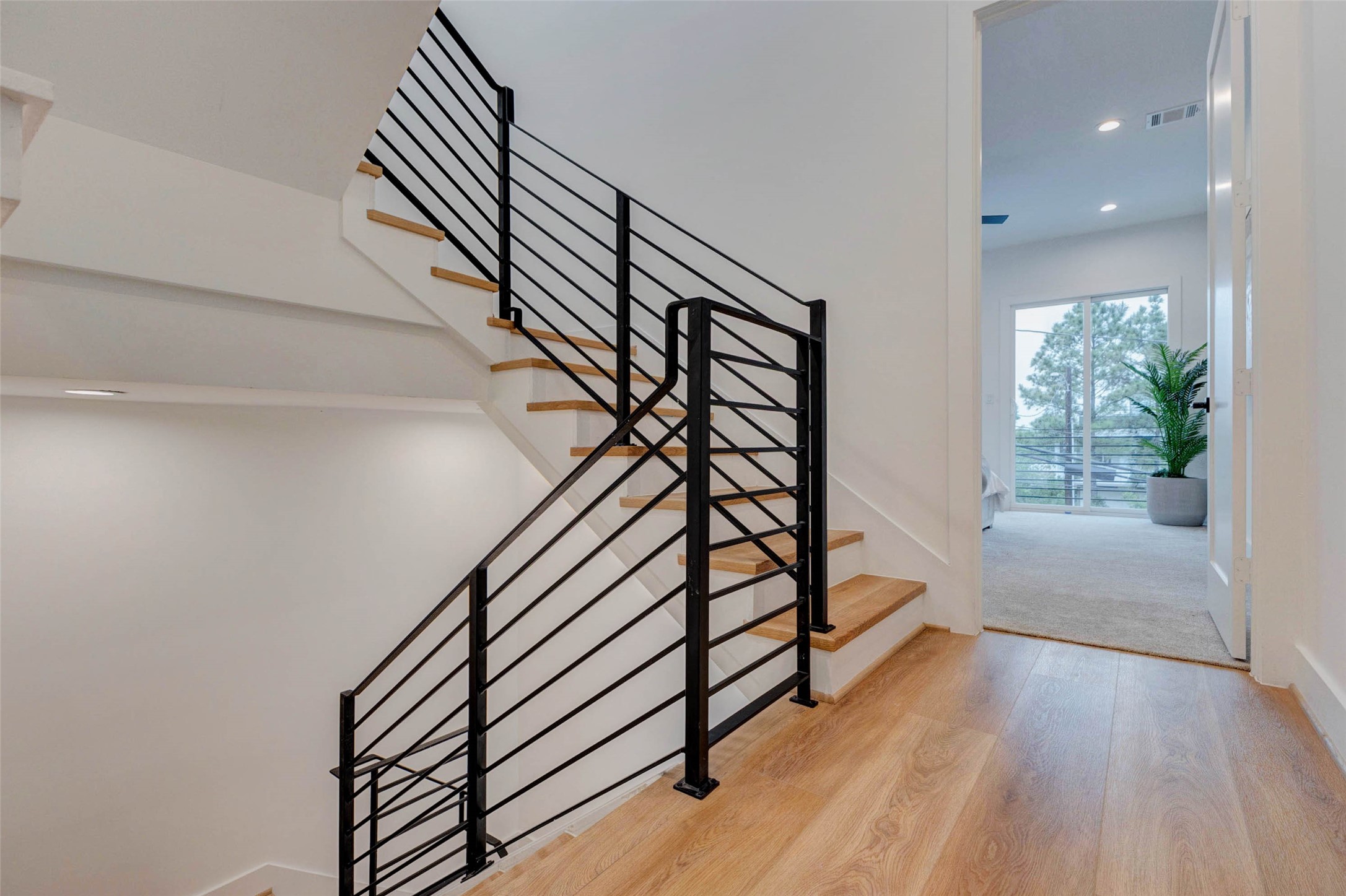 3309 St Emanuel Street Houston, TX 77004 - Photo 35 of 47 Experience modern elegance with sleek nautical railings and luxurious wide vinyl plank flooring throughout.