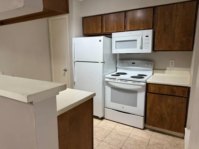 a kitchen with a stove a refrigerator and a sink