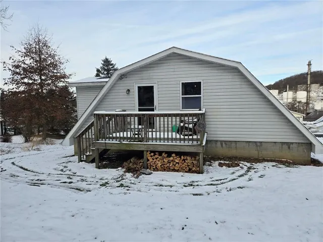 a view of a house with a wooden deck
