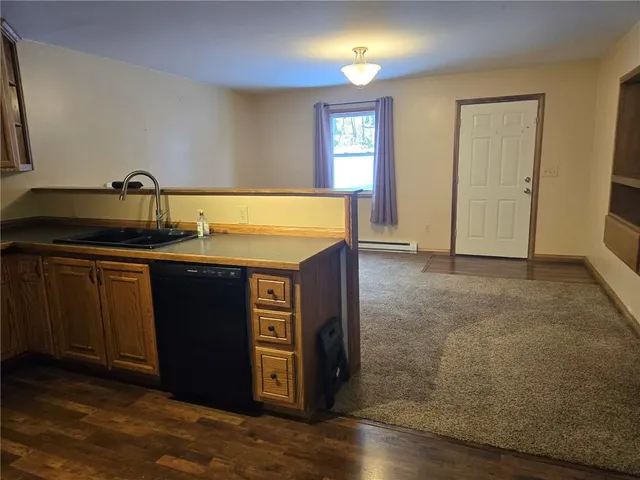 a kitchen with kitchen island sink and faucet