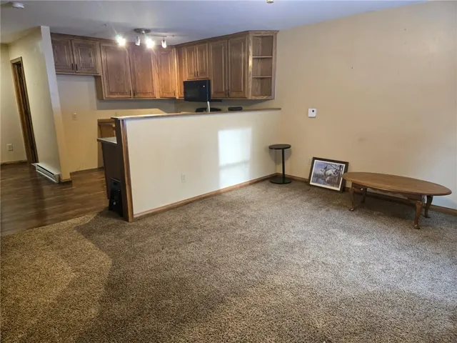 a view of kitchen with refrigerator stove and a sink