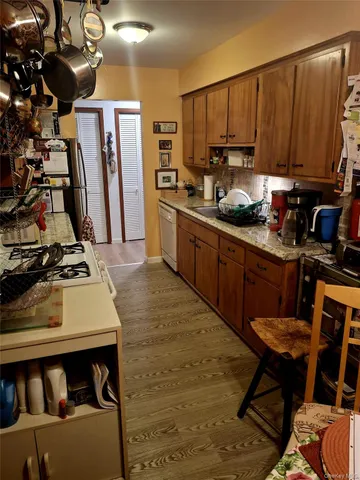 a kitchen with stainless steel appliances granite countertop a stove refrigerator sink and cabinets