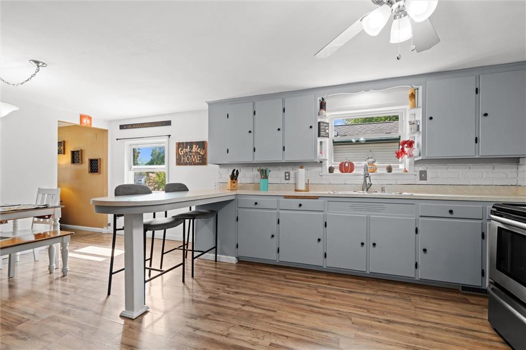 56 Concord Road Hermitage, PA 16148 - Photo 7 of 23 a kitchen with a sink cabinets and wooden floor