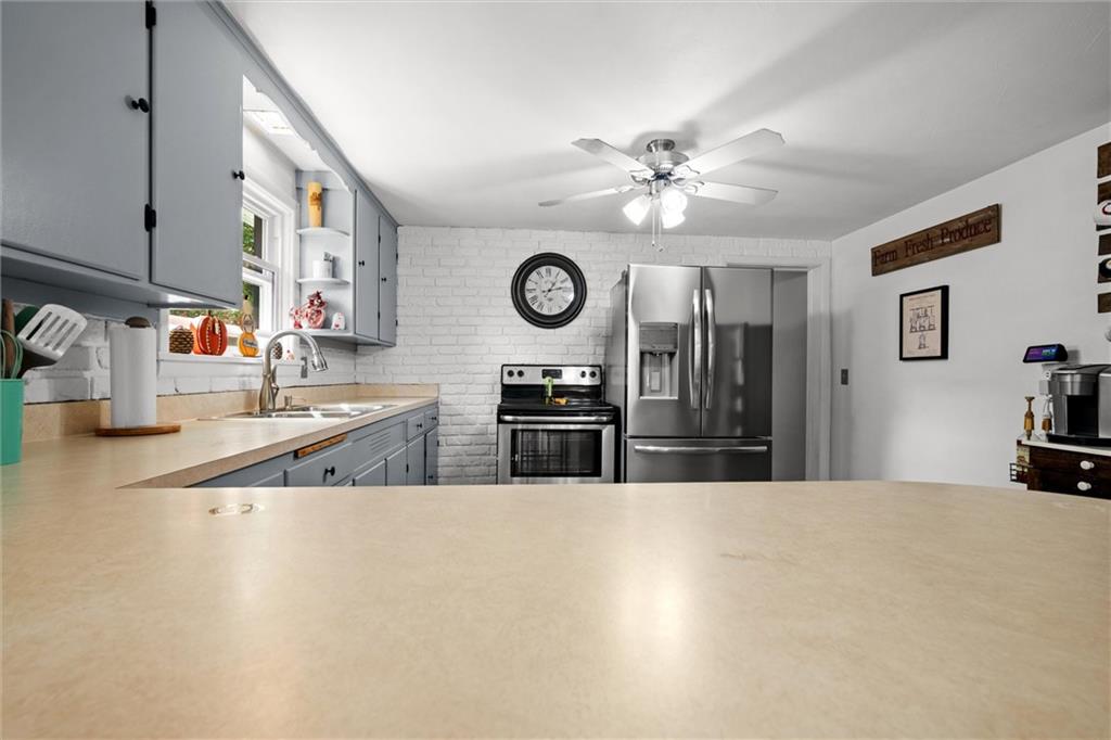 56 Concord Road Hermitage, PA 16148 - Photo 8 of 23 a kitchen with stainless steel appliances granite countertop a sink a stove and a refrigerator with wooden floor