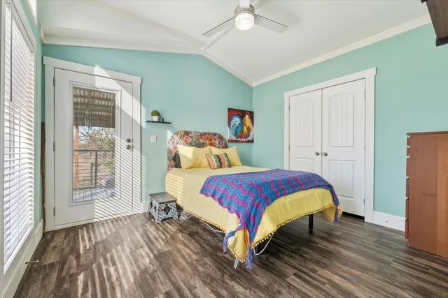 a bedroom with a bed and a large window