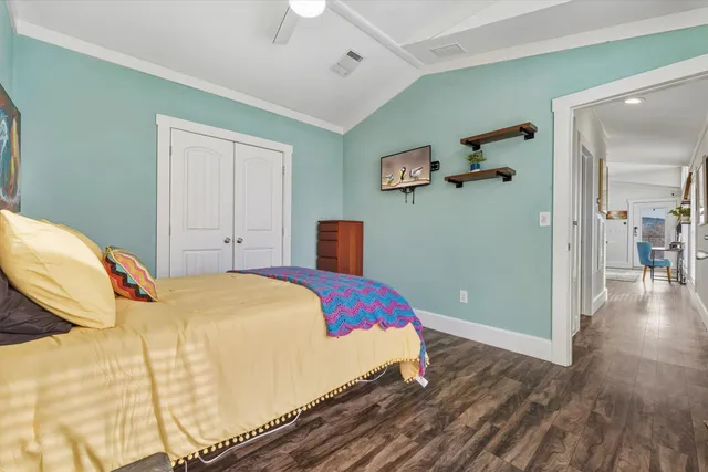 a bedroom with a bed and wooden floor