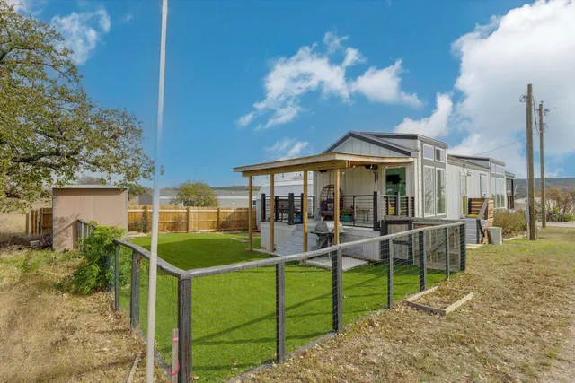 a view of a house with a backyard