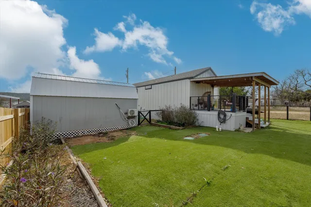 a backyard of a house with table and chairs