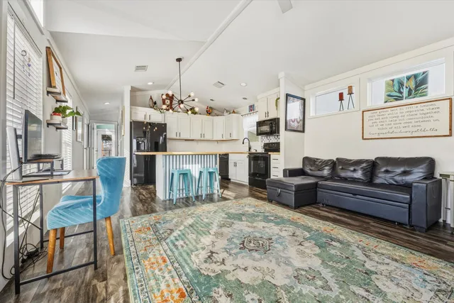 a living room with furniture a fireplace and a flat screen tv