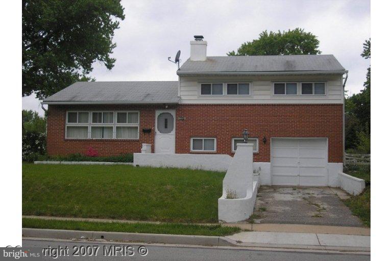 6007 Johnnycake Road Catonsville, MD 21228 - Photo 1 of 1 a front view of a house with a garden