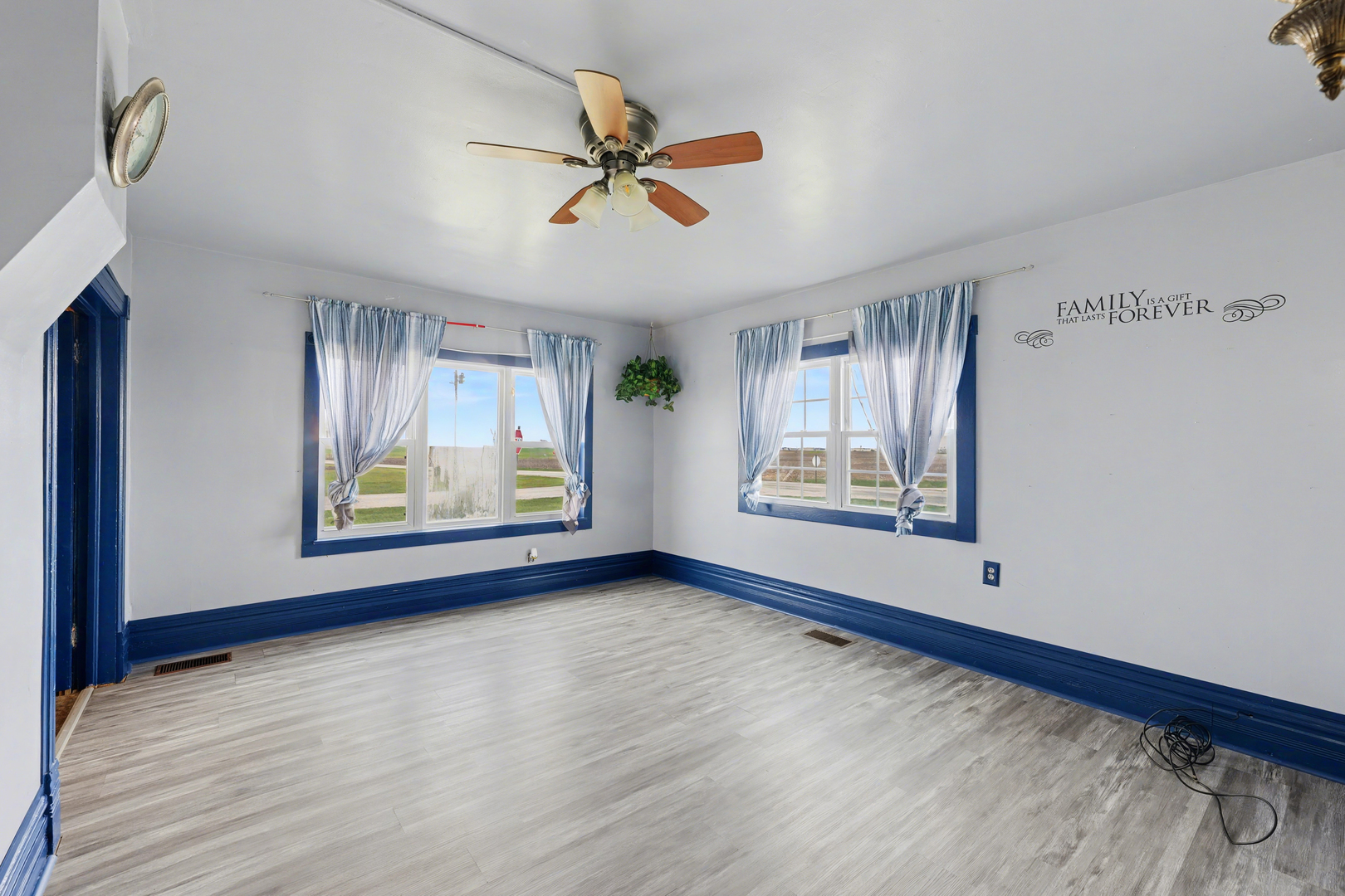 724 East 2600 North Road Penfield, IL 61862 - Photo 22 of 43 a view of an empty room with window and wooden floor