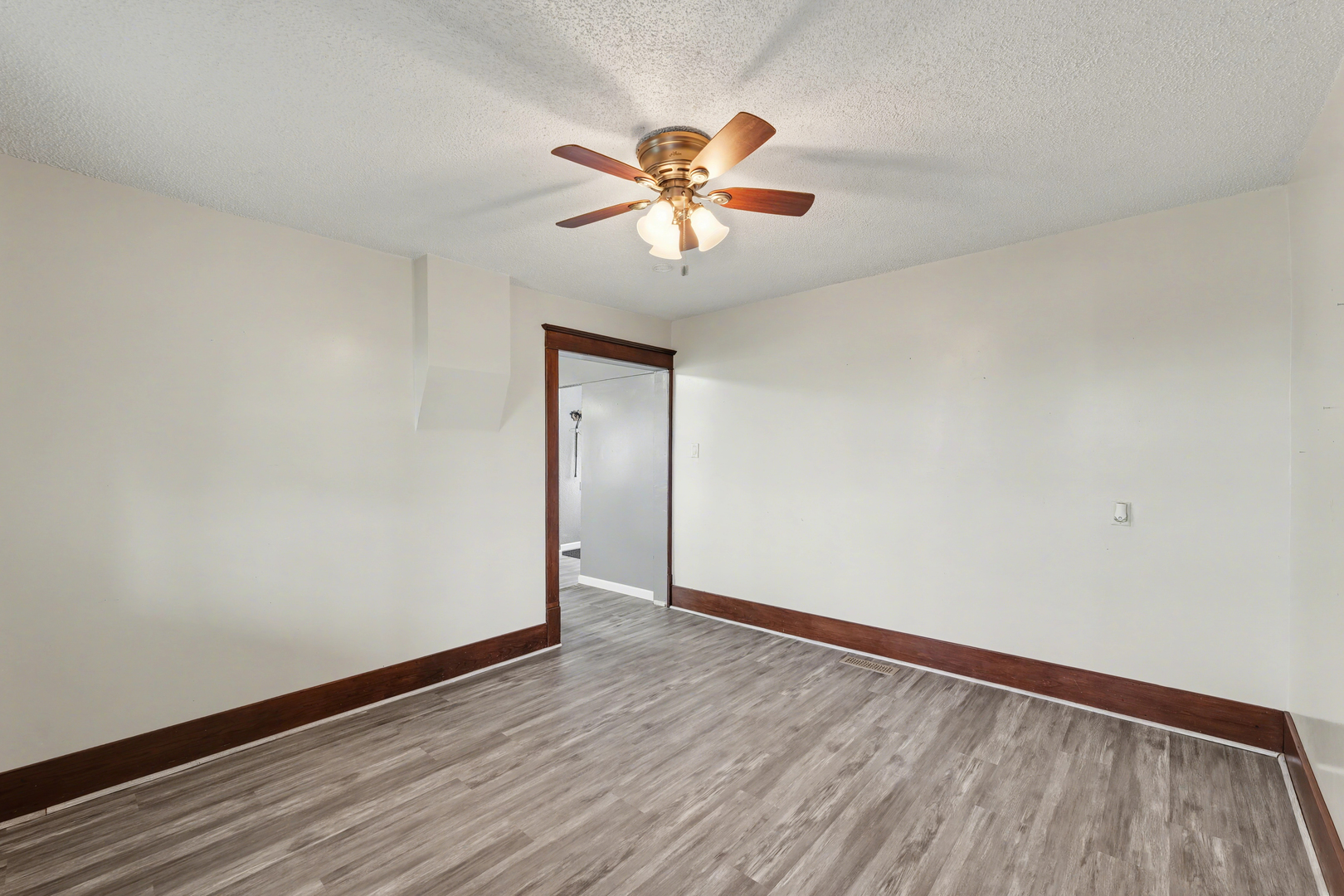 724 East 2600 North Road Penfield, IL 61862 - Photo 9 of 43 a view of an empty room with window and wooden floor