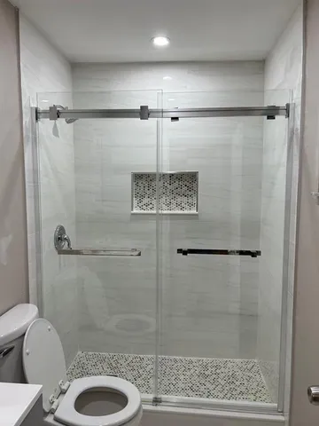 a bathroom with a shower and toilet