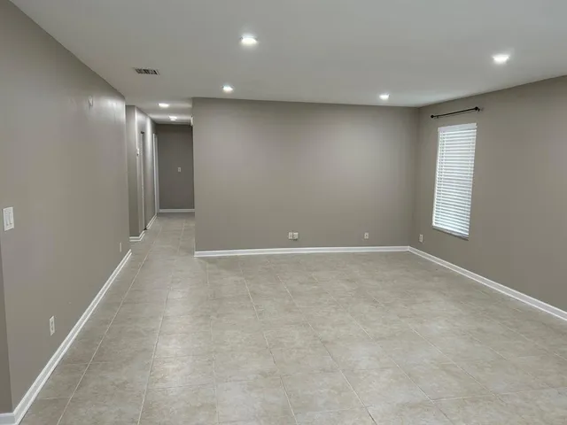 an empty room with windows and closet